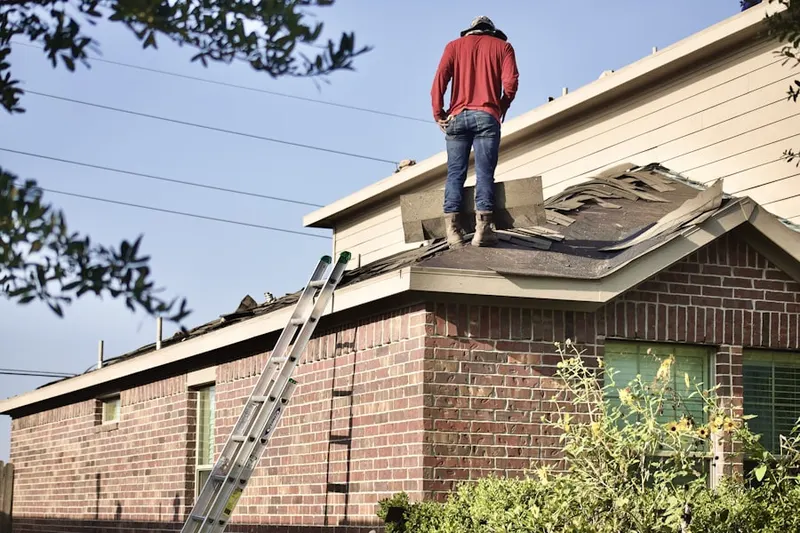 Professional roofer working on a residential roof in Sun City